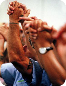 clasped_hands Kairos Inside Graduate prisoners raising clasped hands in celebration